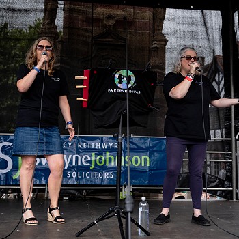 2 women on stage singing