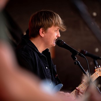 man playing a guitar and singing